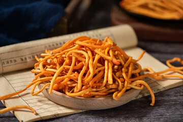 Golden cordyceps mushrooms on wooden table. © zhikun sun