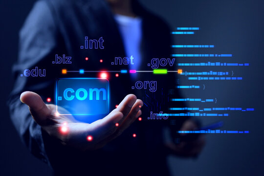 Domain name concept with businessman holding .com to be a top level of website domain in business webpage globally recognized dot com to default choice highly recognizable and valuable
