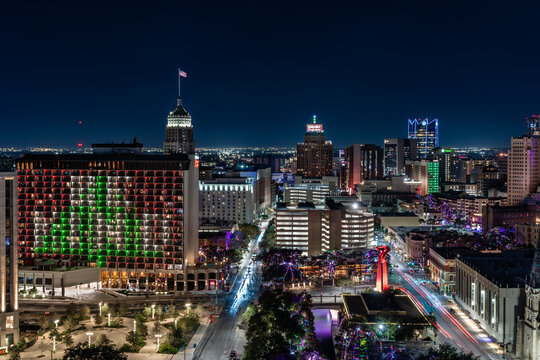 San Antonio, Texas, USA - December 2, 2025:  Exterior night time view of the downtown, city center area and River Walk in San Antonio, TX, with holiday lights.
