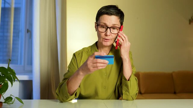 Shocked worried senior woman talking on smartphone with financial scammers and sharing personal data. Trusting feared lady being tricked by fake bank employees with dishonest manipulative schemes.