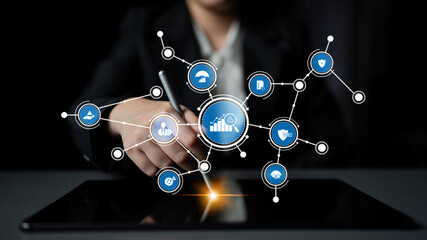 A business professional engages with a digital tablet, illustrating data trends and technological connections in a modern workspace for effective analysis and decision-making. Tessel