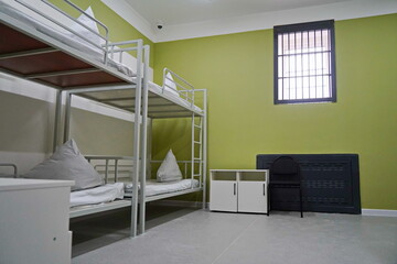 The bed linen is on the bed. A prison cell in a penal colony.