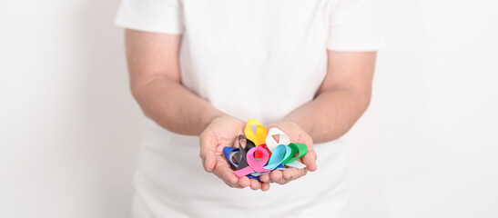 World cancer day, February 4. Elderly with colorful ribbons, blue, yellow, red, green, white, pink...