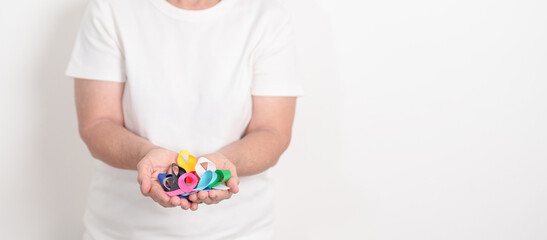 World cancer day, February 4. Elderly with colorful ribbons, blue, yellow, red, green, white, pink and grey for supporting people living and illness. Health, Medical, awareness and Insurance concept