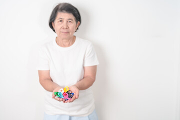 World cancer day, February 4. Elderly with colorful ribbons, blue, yellow, red, green, white, pink...