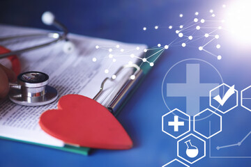 Stethoscope, test tubes, laptop, prescriptions, glasses on the table. Doctor`s desk in the clinic's...