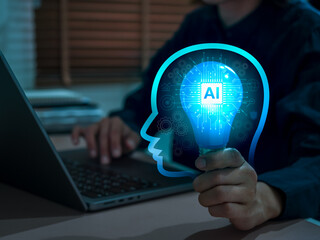 Artificial Intelligence concept with smart brain and AI chip on light bulb in head shape holding by tech developer hand. Machine learning, automation, Ai agents, innovation and digital transformation.