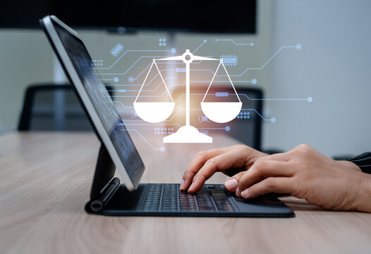 Concept of AI regulations and digital law with virtual scale of justice icon and circuit appear while hands work with tablet. Ethical AI, legal compliance and technology governance in the digital age.