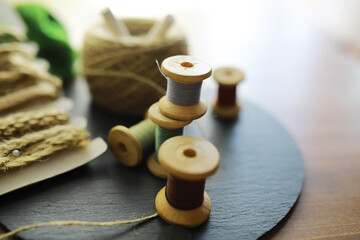 Old scissors, spools of colored thread, centimeter and tailors chalk, flat lay, concept of sewing clothes