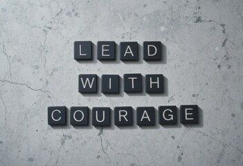 Fototapeta premium Inspirational Message Lead with Courage on Concrete Background