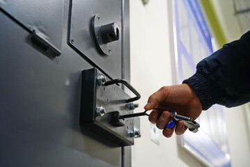 An employee of the colony closes the cell for prisoners.