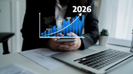 A business professional reviews financial growth trends on a smartphone and laptop, surrounded by...