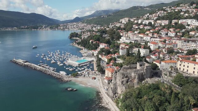 Drone footage capture a scenic panorama of Herceg Novi, a historic coastal Adriatic town nestled in southern Montenegro. Aerial view.