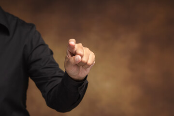 Pointing finger gesture representing choice and leadership.