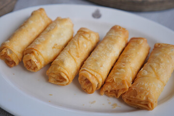 Crispy spring rolls served on a white plate