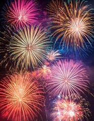 Colorful firework explosions illuminating a dark night sky