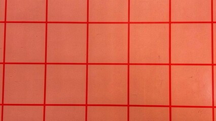 Naklejka premium Minimalist red grid pattern over a smooth reddish-orange background