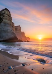 Majestic coastal cliffs frame a brilliant sunrise over tranquil ocean waters.