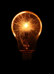 Glowing light bulb with sparks