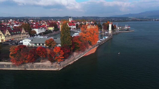 Obersee Bodensee Landau Germany Switzerland aerial drone harbor view island fall autumn leaves golden hour sunset clouds shoreline marina sailboat ferries European lake Constance circle right up