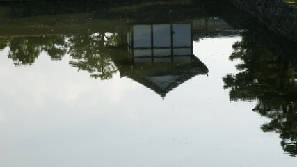 Restored Momoyamamon Gate reflects in water of Nijo Castle moat, Kyoto