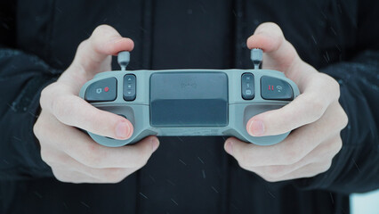 FPV drone operator, close-up, face with glasses