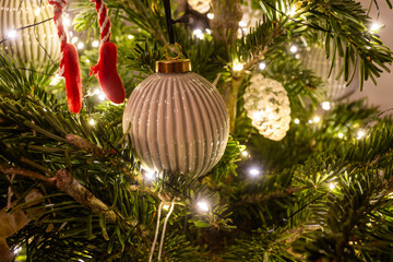 Elegant Neutral Christmas Ornament on Festive Tree with Warm Lights