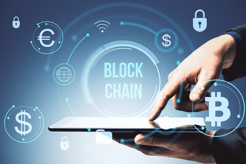 Businessperson using digital tablet with blockchain and cryptocurrency symbols on glowing background, showcasing modern financial technology concept.