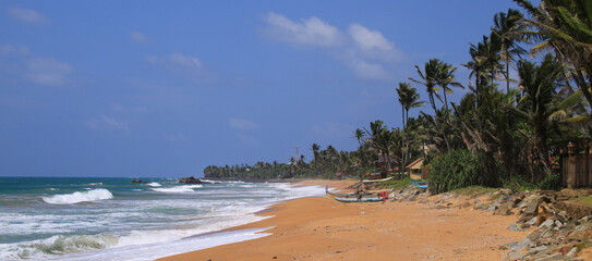 Coco palms, blue sea and sand beach, Bara Beach, Galle, Sri Lanka.