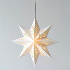 Obraz premium White paper star lantern lit against gray background