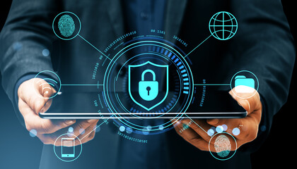 Cybersecurity lock shield symbol on digital tablet held by businessman with virtual icons for secure data protection and privacy concept.