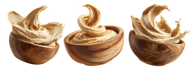 Fototapeta premium Swirled creamy hummus in wooden bowl, isolated on white transparent background. Concept of healthy vegan food and dip
