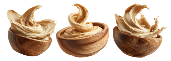 Swirled creamy hummus in wooden bowl, isolated on white transparent background. Concept of healthy vegan food and dip
