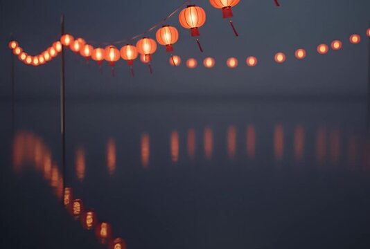 Row of glowing red lanterns hanging from a wire