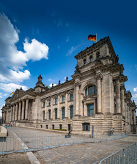 Obraz premium Front view of Reichstag building. Historic Reichstag architecture in Berlin. Reichstag Political symbol of Germany. German flag over Reichstag.