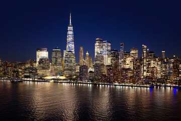 Obraz premium New York City skyscrapers forming a panoramic landscape. New York skyline with the Manhattan Tower. NYC aerial cityscape view. New York City Hudson River skyline. New York night metropolis skyline.