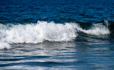 Glowing sea waves shimmer in daylight. Ocean wave rise high. Bright sea waves background. Blue green sea waves patterns. Sea waves of nature.