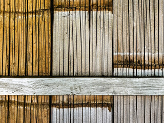 Vertical dry bamboo fence texture for pattern and background. Decorative old bamboo fence or wall texture background for design. Split bamboo pieces bundled together to form a simple fence or wall.