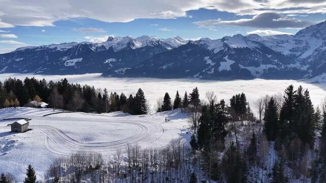 snowy walensee hillside meets dark forest as cloud ocean glows below churfirsten