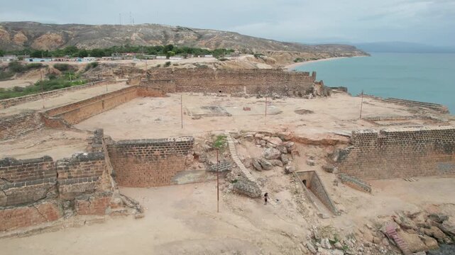 Aerial view of Castillo Araya by the sea with rocky terrain and ruins