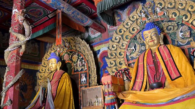 Ancient Buddhist heritage at Erdene Zuu Monastery: a row of gilded statues, ceremonial cymbals, and intricate colorful woodwork adorn the sanctuary of Mongolia's first Buddhist center.