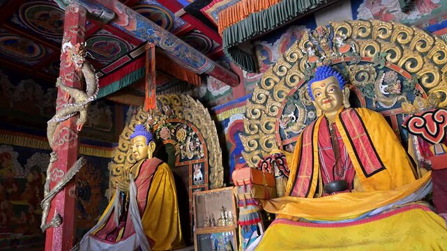 Historic interior of Erdene Zuu, Mongolia. Features detailed golden Buddha deities, sacred Tibetan-style shrines, and preserved religious artifacts in the main prayer hall.