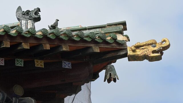 Historic roof detail at Erdene Zuu, Mongolia's oldest monastery. The green tiled pavilion features a golden Dharma Wheel flanked by deer, a traditional symbol of Buddhist teaching and ancient heritage