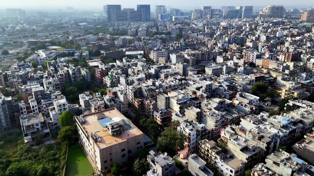 Metro Line and Affluent Residential: Drone footage of the elevated metro line cutting through green, low-rise residential plots near the city center.