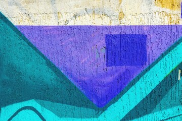 Geometric street art featuring bold teal, purple shapes on weathered wall. Urban 90s style, vibrant contrast, textured surface. Murals, graffiti-inspired design, modern creative visuals, cityscape art