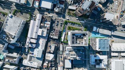 Fototapeta premium Drone directly above aerial view of modern city buildings and roads.