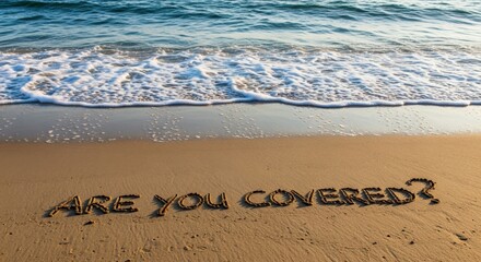 Fototapeta premium Inspirational Message 'Are You Covered?' Written in Sand on a Beach with Waves