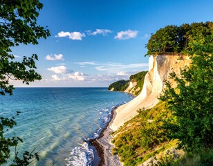 Coastal cliffside meets ocean under blue sky, dappled sunlight on the edge