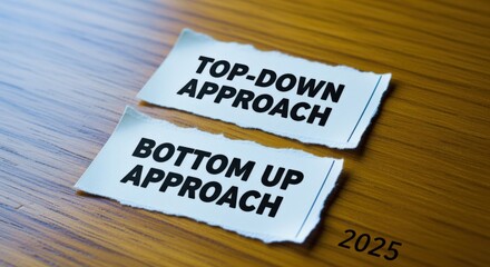 Top-Down and Bottom-Up Approaches Strategy Concept: Two Different Strategies Represented by Torn Paper on a Wood Surface