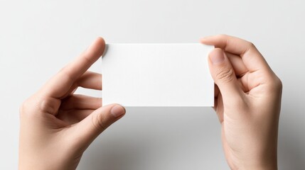 Hands Holding Blank Business Card Mockup on White Backdrop for Branding Presentation
